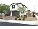 Charming two-story home features a brown garage door and desert landscaping at 4109 Cloudless Ave, North Las Vegas, NV 89081