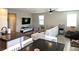 Open-concept living room with modern furniture and wood-look tile floors at 4109 Cloudless Ave, North Las Vegas, NV 89081