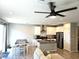 Open-concept living room with modern furniture, adjacent to kitchen and dining area at 4109 Cloudless Ave, North Las Vegas, NV 89081