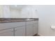 Bathroom vanity with stone countertop and grey cabinets at 4145 Lunar Canyon Ave, North Las Vegas, NV 89084