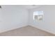 Empty bedroom with neutral carpet, white walls, and a bright window at 4145 Lunar Canyon Ave, North Las Vegas, NV 89084