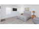 Bedroom with bed, side tables, and television with gray wood flooring at 4145 Lunar Canyon Ave, North Las Vegas, NV 89084
