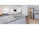 Modern kitchen with granite countertops, stainless steel appliances, and breakfast bar at 4145 Lunar Canyon Ave, North Las Vegas, NV 89084