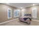 Neutral bedroom with large windows, shutters, carpet flooring, and base trim at 4193 Solace St # 4193, Las Vegas, NV 89135