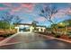 A beautifully landscaped entrance featuring a brick-paved drive and elegant gate with accent lighting at 4193 Solace St # 4193, Las Vegas, NV 89135