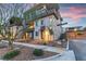 Contemporary three-story home with modern design and inviting front landscape at sunset at 4193 Solace St # 4193, Las Vegas, NV 89135