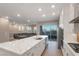 Open kitchen features a large quartz island, stainless appliances, gas range, and sliding glass doors to the patio at 4193 Solace St # 4193, Las Vegas, NV 89135