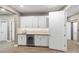 Stylish wet bar featuring white cabinetry, stone countertops, a sink, and wine fridge at 4193 Solace St # 4193, Las Vegas, NV 89135