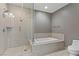 Bathroom includes glass enclosed shower, soaking tub, and neutral tiling at 4575 Dean Martin Dr # 1208, Las Vegas, NV 89103