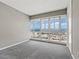 Carpeted bedroom features city views through expansive windows at 4575 Dean Martin Dr # 1208, Las Vegas, NV 89103