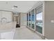 Modern kitchen featuring white cabinets, stainless steel appliances, and marble countertops with balcony door access at 4575 Dean Martin Dr # 1208, Las Vegas, NV 89103