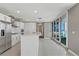 Modern kitchen with white cabinets, stainless appliances, and a central island adjacent to bright balcony doors at 4575 Dean Martin Dr # 1208, Las Vegas, NV 89103