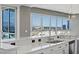Well-lit kitchen island with stainless steel sink and faucet surrounded by city views from large windows at 4575 Dean Martin Dr # 1208, Las Vegas, NV 89103