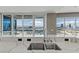 A modern kitchen island sink with faucet and expansive city views from large windows at 4575 Dean Martin Dr # 1208, Las Vegas, NV 89103