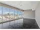 Bright living room featuring dark wood floors, modern light fixture, and large windows showcasing a beautiful city view at 4575 Dean Martin Dr # 1208, Las Vegas, NV 89103