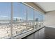 Bright living room featuring dark wood floors and large windows showcasing a beautiful city view at 4575 Dean Martin Dr # 1208, Las Vegas, NV 89103