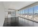 Bright living room with dark wood floors offering a view of the modern kitchen and city skyline beyond at 4575 Dean Martin Dr # 1208, Las Vegas, NV 89103