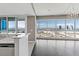 Open concept living space with bar and expansive windows showcasing city skyline at 4575 Dean Martin Dr # 1208, Las Vegas, NV 89103