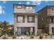 Charming two-story home with a blue front door, desert landscaping, and a modern gray color scheme at 4665 Parkarbor Ave, Las Vegas, NV 89141
