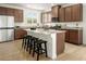 Modern kitchen features stainless appliances, a large island with seating, and granite countertops at 4665 Parkarbor Ave, Las Vegas, NV 89141