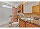 Cozy bathroom with a single sink vanity, warm lighting, and a shower-tub combo at 468 Potomac St, Henderson, NV 89015