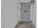 Close-up of the front door featuring security gate, door number, welcome mat, and outdoor light fixture at 468 Potomac St, Henderson, NV 89015
