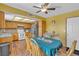 Warm eat-in kitchen with a ceiling fan, wood cabinets, and laminate flooring at 468 Potomac St, Henderson, NV 89015