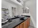 Modern bathroom featuring a double sink vanity with vessel sinks, black countertops and sleek fixtures at 4878 Friar Tuck Ave, Las Vegas, NV 89130
