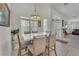 Bright dining area with large windows, modern chandelier, and comfortable seating, perfect for Gathering gatherings and entertaining guests at 4878 Friar Tuck Ave, Las Vegas, NV 89130