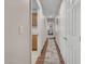 Hallway with hardwood floors and white doors, creating a clean and inviting transition between rooms at 4878 Friar Tuck Ave, Las Vegas, NV 89130