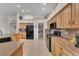 Bright kitchen features stainless steel appliances, tile flooring, and ample counter space for culinary enthusiasts at 4878 Friar Tuck Ave, Las Vegas, NV 89130