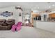Spacious living room with hardwood floors, plush carpet, and a seamless transition to the kitchen area at 4878 Friar Tuck Ave, Las Vegas, NV 89130