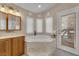 Inviting bathroom with a jacuzzi tub, bright lighting, and a relaxing ambiance for unwinding after a long day at 4878 Friar Tuck Ave, Las Vegas, NV 89130