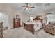 Comfortable main bedroom with a ceiling fan, carpeted floors, and an abundance of natural light at 4878 Friar Tuck Ave, Las Vegas, NV 89130