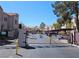Gated community entrance with covered parking and desert landscaping at 5225 W Reno Ave # 210, Las Vegas, NV 89118