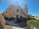 Condominium exterior showing landscaped common areas, walkway, stairs and a peaked roof at 5225 W Reno Ave # 210, Las Vegas, NV 89118
