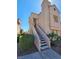 Inviting condominium featuring a private entrance, a stairway and desert landscaping at 5225 W Reno Ave # 210, Las Vegas, NV 89118