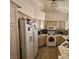 Functional kitchen featuring white appliances, neutral cabinets and tile floors at 5225 W Reno Ave # 210, Las Vegas, NV 89118