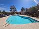 A large community pool features a ladder and is surrounded by desert landscaping at 5225 W Reno Ave # 210, Las Vegas, NV 89118