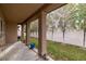 Covered patio with stone columns and a view of the landscaped backyard with young trees at 5265 Lucca Ln, Pahrump, NV 89061