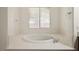 Bright bathroom featuring a large soaking tub with a window at 5265 Lucca Ln, Pahrump, NV 89061