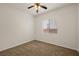 Bedroom features neutral carpet, ceiling fan, and window providing natural light at 5265 Lucca Ln, Pahrump, NV 89061