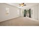Spacious bedroom with multiple windows, a ceiling fan, and sliding glass door to the backyard at 5265 Lucca Ln, Pahrump, NV 89061