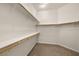 Walk-in closet with multiple shelves and wood rods for maximum storage at 5265 Lucca Ln, Pahrump, NV 89061