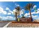 Mountain Falls community entrance with lush palm trees against a bright blue sky at 5265 Lucca Ln, Pahrump, NV 89061