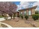 Close up of charming single-story home featuring stone accents and manicured front yard at 5265 Lucca Ln, Pahrump, NV 89061