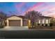 Charming single-story home featuring a well-manicured lawn and a three-car garage at 5265 Lucca Ln, Pahrump, NV 89061