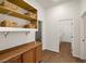 Hallway with built in shelving and wooden cabinets for extra storage and organization at 5265 Lucca Ln, Pahrump, NV 89061