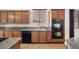 Kitchen featuring wooden cabinets, granite countertops, stainless appliances and double ovens at 5265 Lucca Ln, Pahrump, NV 89061