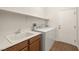 Laundry room area with washer, dryer, utility sink, and tile flooring at 5265 Lucca Ln, Pahrump, NV 89061